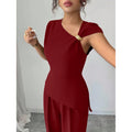 Women's elegant sleeveless fitted top with metal accents and asymmetrical hem, paired with loose straight-leg pants - 2-piece set