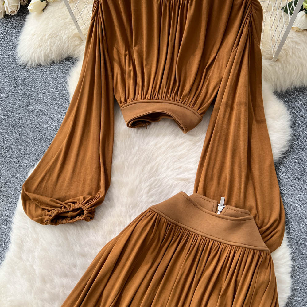 French style women's autumn outfit: elegant cinched-waist cropped lantern sleeve blouse with high-waisted, flowy slit midi skirt two-piece set