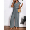 Women's v-neck short sleeve jumpsuit with button-front, elastic waist, wide leg, and pockets - perfect for everyday casual wear