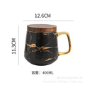 Nordic-inspired ceramic coffee mug, teacup, and saucer set with gold-traced marble pattern and wooden lid