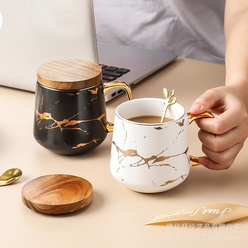 Nordic-inspired ceramic coffee mug, teacup, and saucer set with gold-traced marble pattern and wooden lid