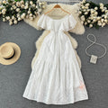 Elegant, sophisticated, and effortlessly chic: this ruffled, off-the-shoulder, lace-embroidered, and cutout maxi dress is perfect for a glamorous beach vacation