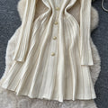 French chic, high-end, luxurious knitted dress with heavily embellished metal buckle – perfect for autumn/winter, featuring a cinched waist and ideal as a layering piece