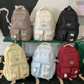 Minimalist korean style fashion casual backpack for high school and college students, featuring cute cartoon badges and large capacity