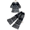 Vacation-ready green floral print two-piece set for women. summer v-neck, slimming wide-leg pants, perfect for both work and play. a stylish and chic outfit