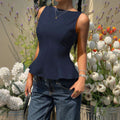 Sleeveless, cinched-waist top for women, featuring a ruffled hem, open back with a bow tie closure. a versatile, ready-to-ship piece perfect for everyday wear. ships within 24 hours