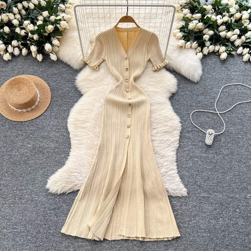Elegant and sophisticated v-neck short-sleeve knit dress for women, perfect for summer. features a slimming, single-breasted design with a slit and shimmering silk details. a long, chic sweater dress