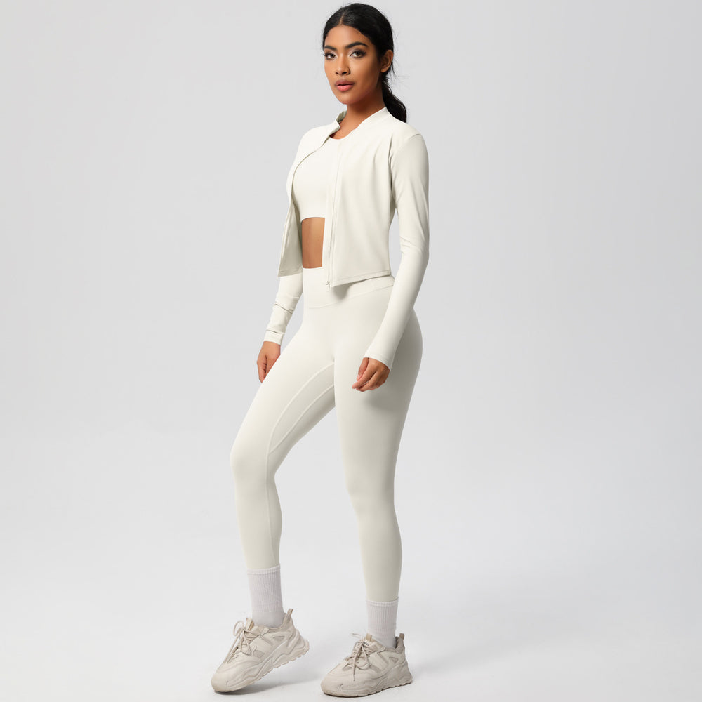 High-waisted, form-fitting yoga pants, a barely-there feel, quick-drying outer layer, and a long-sleeved tee – a women's three-piece activewear set perfect for running and workouts