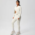 High-waisted, form-fitting yoga pants, a barely-there feel, quick-drying outer layer, and a long-sleeved tee – a women's three-piece activewear set perfect for running and workouts