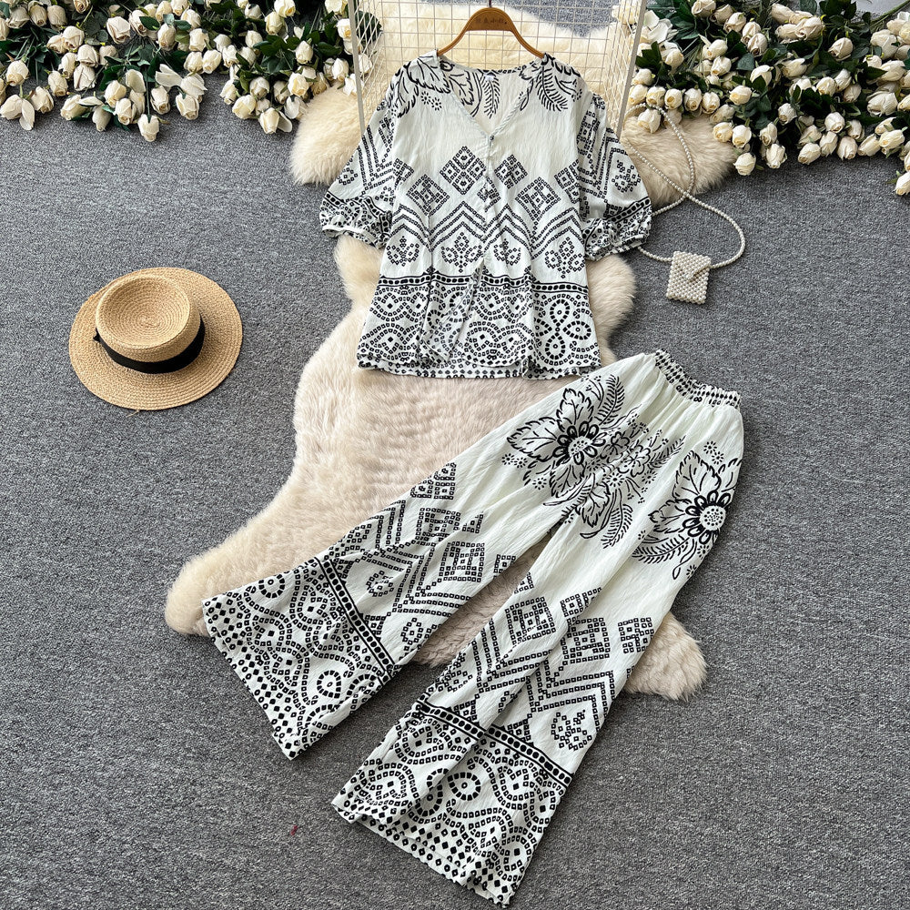 Vacation-ready green floral print two-piece set for women. summer v-neck, slimming wide-leg pants, perfect for both work and play. a stylish and chic outfit