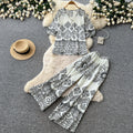 Vacation-ready green floral print two-piece set for women. summer v-neck, slimming wide-leg pants, perfect for both work and play. a stylish and chic outfit