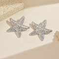 Wholesale seaside earrings: cross-border summer ocean resort style alloy starfish earrings for women - european and american niche exaggerated dangle earrings
