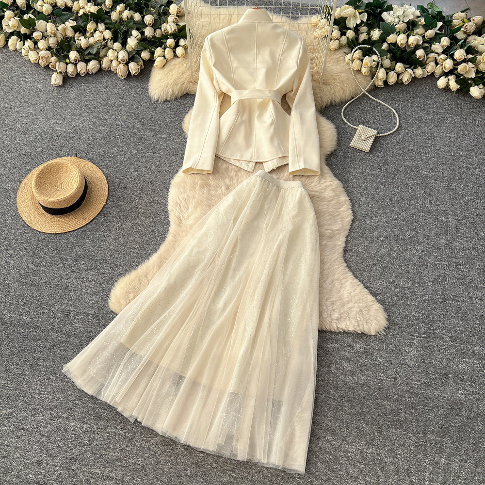 Elegant and chic chanel-inspired two-piece set: women's autumn outfit featuring a tie-waist cardigan and mesh skirt